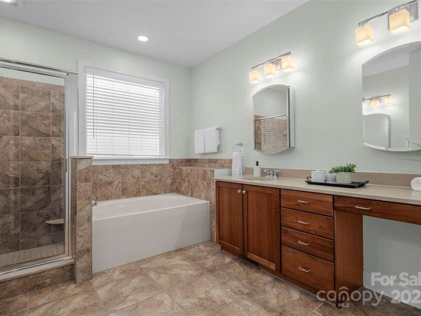 16 La Rue Court, Biltmore Lake, NC 28715.  MLS# CAR4224006, YatesRealty ID 17839. Dual vanities, soaking tub & glass shower in primary suite bath