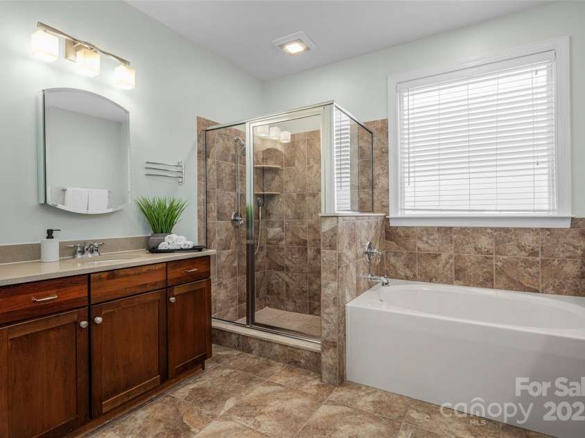 16 La Rue Court, Biltmore Lake, NC 28715.  MLS# CAR4224006, YatesRealty ID 17839. Dual vanities, soaking tub & glass shower in primary suite bath