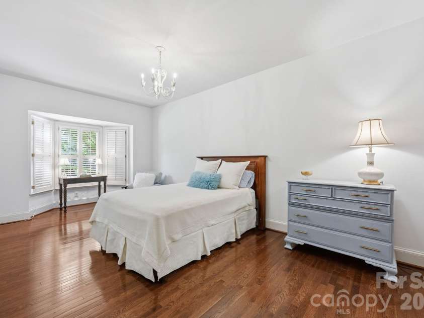 2440 Selwyn Avenue, Charlotte, NC 28209.  MLS# CAR4372591, YatesRealty ID 17843. Large primary bedroom with bay window, manually staged.