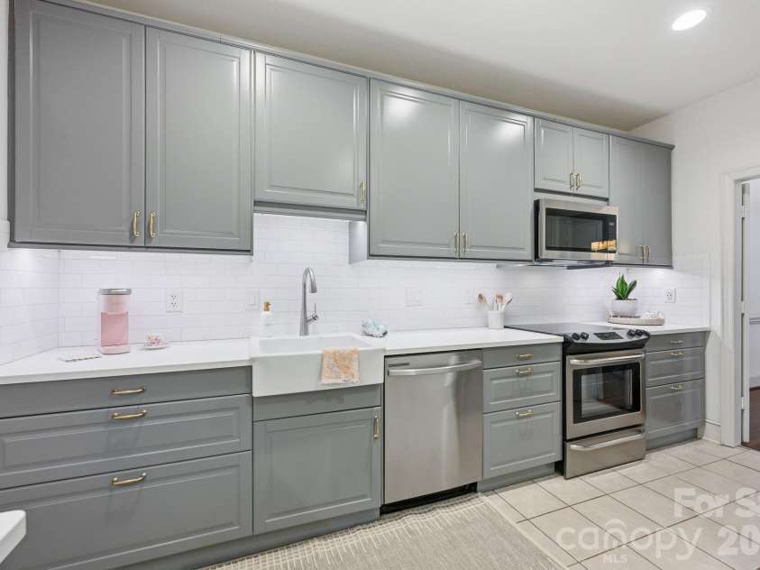 2440 Selwyn Avenue, Charlotte, NC 28209.  MLS# CAR4372591, YatesRealty ID 17843. Tall custom cabinets for high-capacity storage, farm sink, quartz counters.