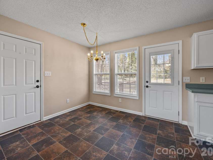 300 Chinaberry Drive, China Grove, NC 28023.  MLS# CAR4346542, YatesRealty ID 1785. Dining area.  Door to back deck and to garage on the left.
