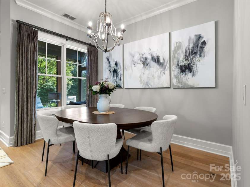 62 Running Creek Trail, Arden, NC 28704.  MLS# CAR4299725, YatesRealty ID 1785. The dining area with large windows that lookout on to the porch.