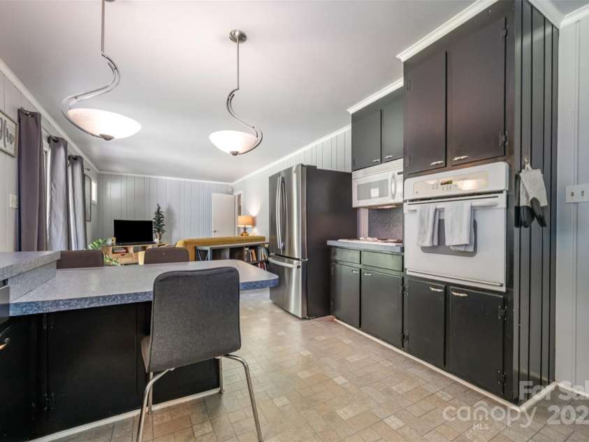 4044 Somerdale Lane, Charlotte, NC 28205.  MLS# CAR4265234, YatesRealty ID 17854. Kitchen leading to den and access to covered back patio