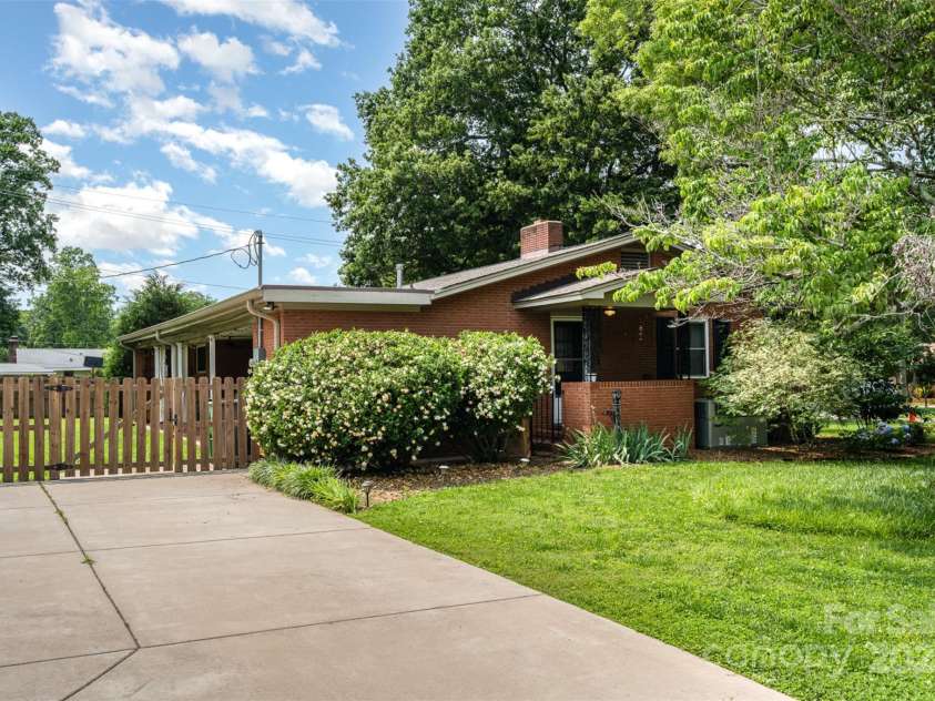 4044 Somerdale Lane, Charlotte, NC 28205.  MLS# CAR4265234, YatesRealty ID 17854. Speaking of gardening !! The lot is covered with mature trees, shrubs, plants and flowers. You will pass this ginormous Gardenia as you enter the side door into the kitchen.
