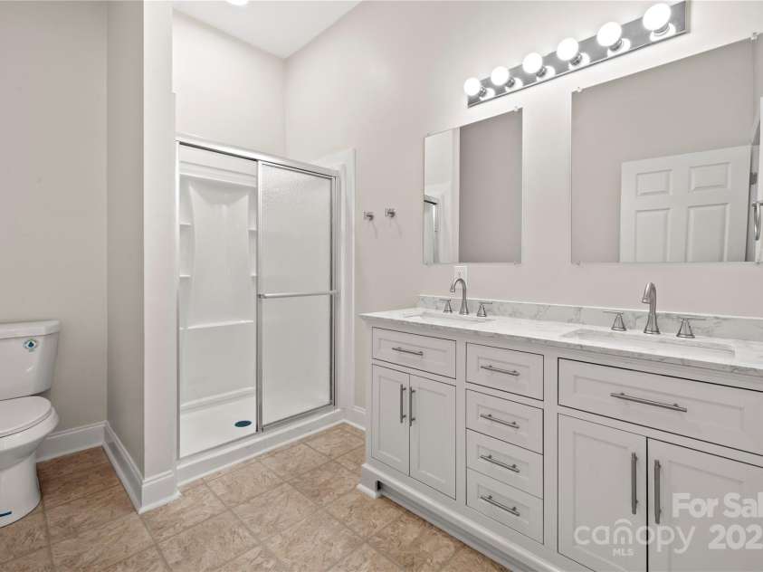 167 Saluda Street, Chester, SC 29706.  MLS# CAR4232529, YatesRealty ID 17857. Primary bath with double vanity and step in shower
