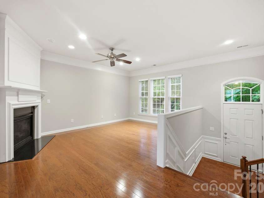 645 Sixth Baxter Crossing, Fort Mill, SC 29708.  MLS# CAR4373614, YatesRealty ID 17860. Living room with large windows overlooking the tree lined street
