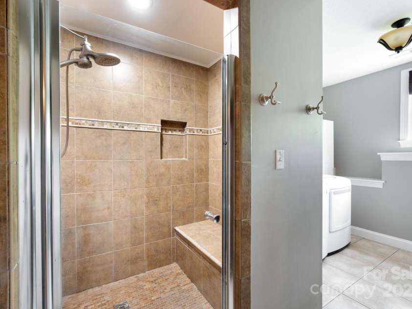 69 Heslar Way, Marshall, NC 28753.  MLS# CAR4246507, YatesRealty ID 17875. Lower-level bathroom with tiled shower