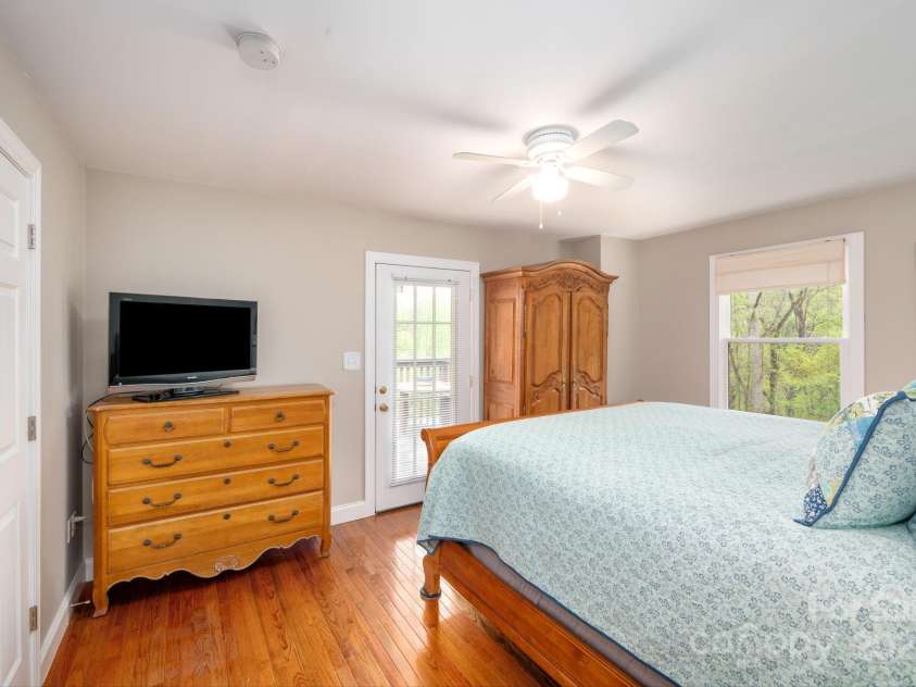 69 Heslar Way, Marshall, NC 28753.  MLS# CAR4246507, YatesRealty ID 17875. Main level primary bedroom porch doorway