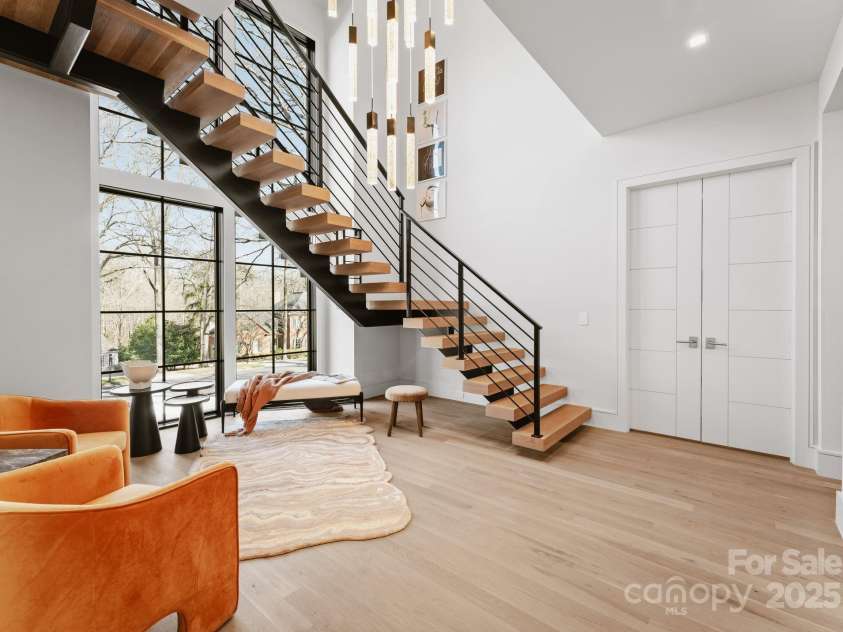 2103 Cortelyou Road, Charlotte, NC 28211.  MLS# CAR4214661, YatesRealty ID 17880. Floating Staircase with Oversized Cascading Chandelier