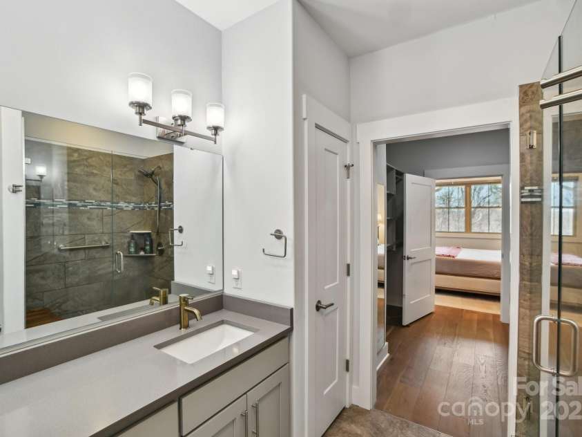 22 Thornes Lane, Asheville, NC 28805.  MLS# CAR4222972, YatesRealty ID 17882. Primary bath double sink looking to walk in closet and primary bedroom