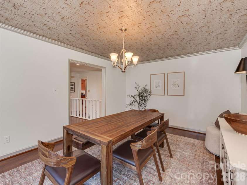 7244 Terrace Drive, Charlotte, NC 28211.  MLS# CAR4357695, YatesRealty ID 17887. Entertain in this stunning dining room, where a showstopping ceiling, finished in a richly textured, patina-inspired treatment, adds warmth, depth, and a touch of the unexpected, setting the stage for evenings filled wi