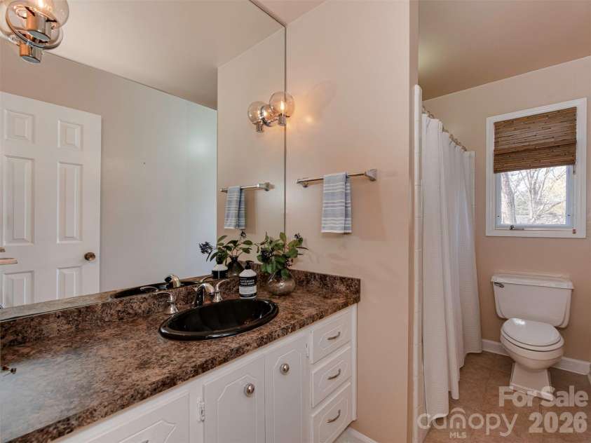 7244 Terrace Drive, Charlotte, NC 28211.  MLS# CAR4357695, YatesRealty ID 17887. Kick off your day in this bright and functional bathroom, featuring a spacious vanity with rich countertops, modern lighting, and a clean, neutral palette.