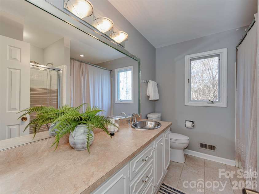 7244 Terrace Drive, Charlotte, NC 28211.  MLS# CAR4357695, YatesRealty ID 17887. Refresh and unwind in this light-filled bathroom, where a spacious vanity, clean finishes, and soft natural light create a calm, everyday retreat. With generous counter space and a bright, airy feel, this space offers t