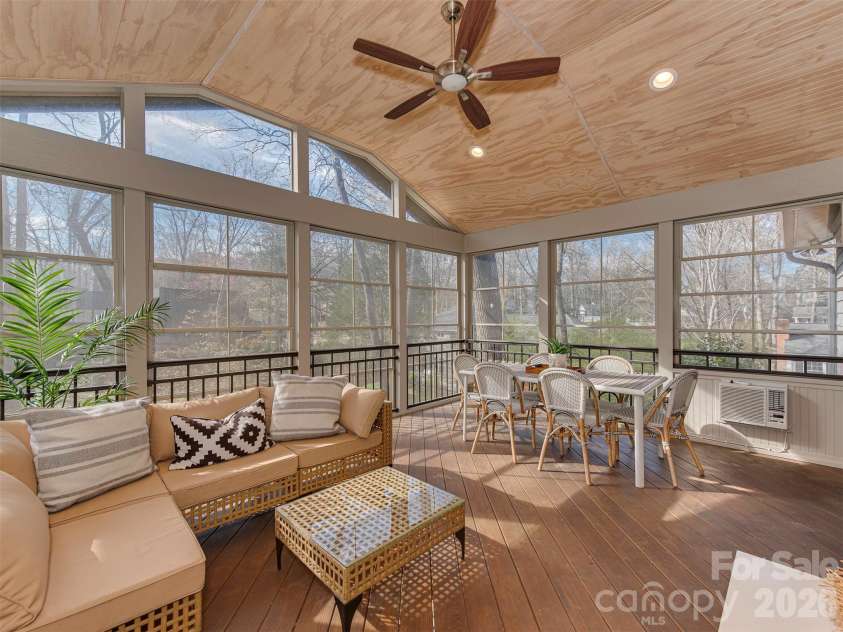 7244 Terrace Drive, Charlotte, NC 28211.  MLS# CAR4357695, YatesRealty ID 17887. Soak in the beauty of this stunning, four season room, perfectly designed for year-round enjoyment. With walls of windows that invite in natural light and frame peaceful outdoor views, this retreat offers a warm, airy f