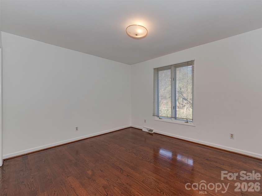 7244 Terrace Drive, Charlotte, NC 28211.  MLS# CAR4357695, YatesRealty ID 17887. This secondary bedroom, located on the main floor, offers a lot of space and a generously sized closet, perfect for comfort, flexibility, and everyday living.