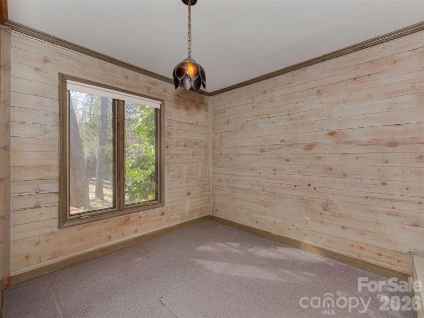 7244 Terrace Drive, Charlotte, NC 28211.  MLS# CAR4357695, YatesRealty ID 17887. This spacious room, previously used for storage, offers endless possibilities. Continue to use it for storage, or transform it into a home office, gym, or even expand the laundry area just across the wall in the adjacen
