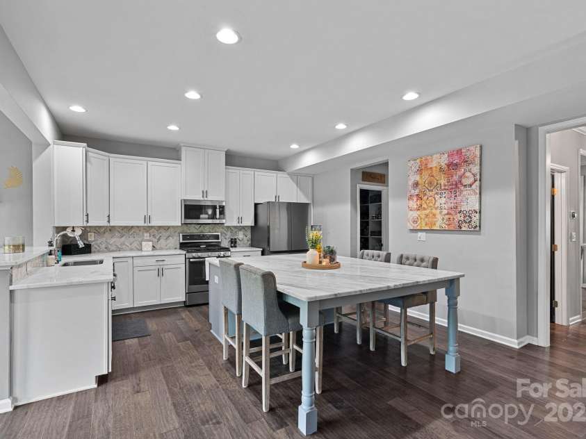 7331 Millstone Circle, Concord, NC 28025.  MLS# CAR4261579, YatesRealty ID 17892. Chef's Kitchen Featuring Brazilian Carrea Marble Counters & Oversized Island