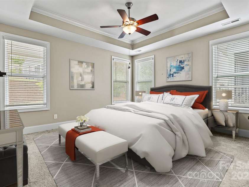 7362 Overjoyed Crossing, Charlotte, NC 28215.  MLS# CAR4259444, YatesRealty ID 17894. VIRTUALLY STAGED  Primary Bedroom showcases the great natural light, neutral paint and carpet and the tray ceiling that draws your eye upward.