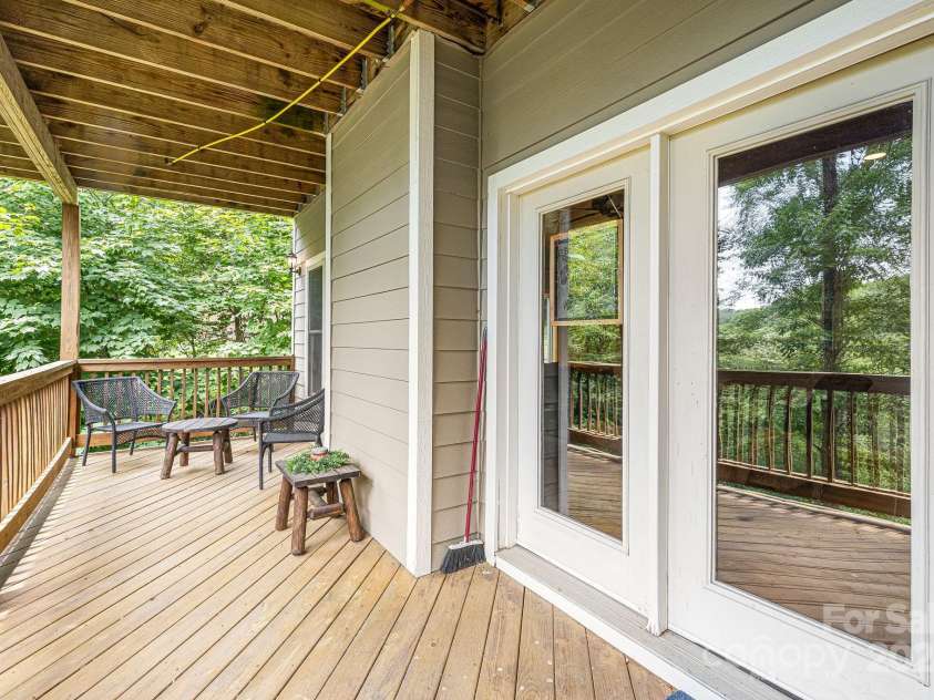 195 El Miner Court, Mars Hill, NC 28754.  MLS# CAR4174195, YatesRealty ID 179. Main level covered deck with fire pit.