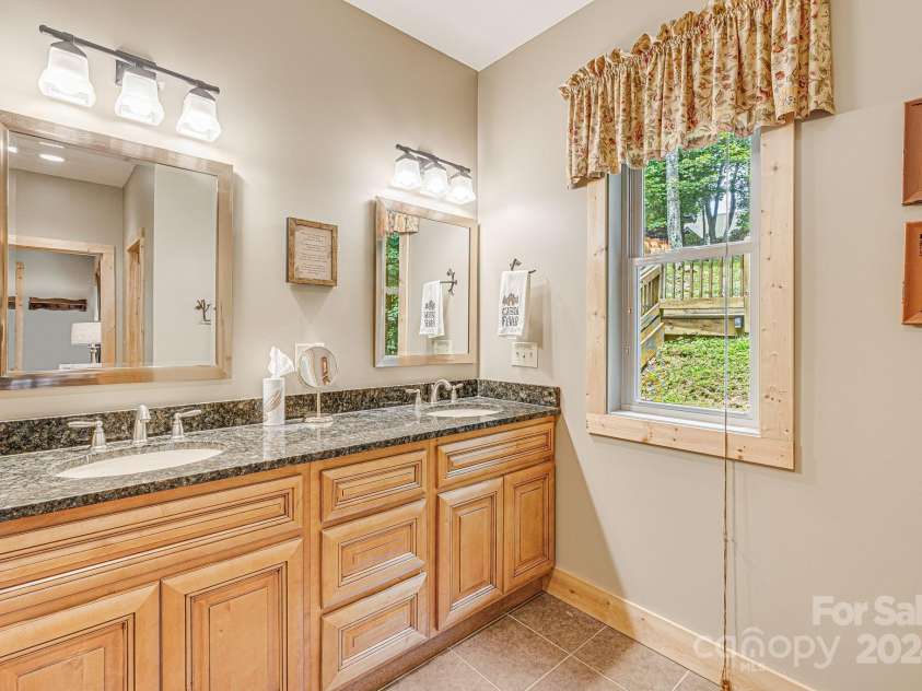 195 El Miner Court, Mars Hill, NC 28754.  MLS# CAR4174195, YatesRealty ID 179. Main level ensuite primary bedroom.