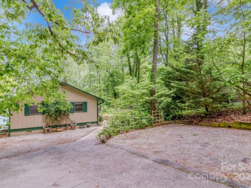 609 Haven Drive, Saluda, NC 28773.  MLS# CAR4247056, YatesRealty ID 17919. Back of home with parking area on right
