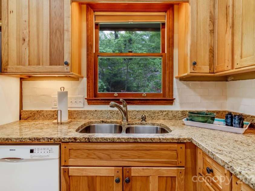 609 Haven Drive, Saluda, NC 28773.  MLS# CAR4247056, YatesRealty ID 17919. Kitchen looks out into the beautiful woods