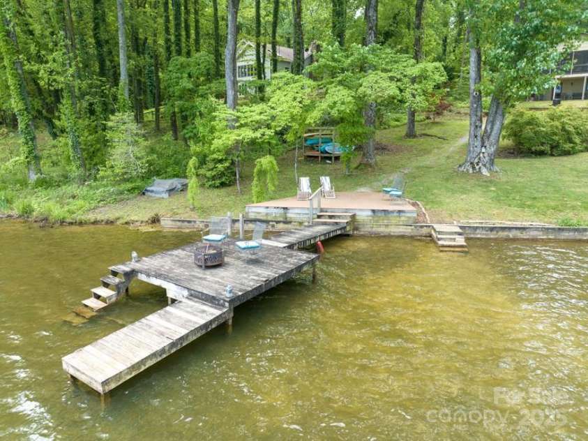 609 Haven Drive, Saluda, NC 28773.  MLS# CAR4247056, YatesRealty ID 17919. Upper party deck, lower dock and two staircases into the water and third level deck for layout on and for getting into and out of boats.