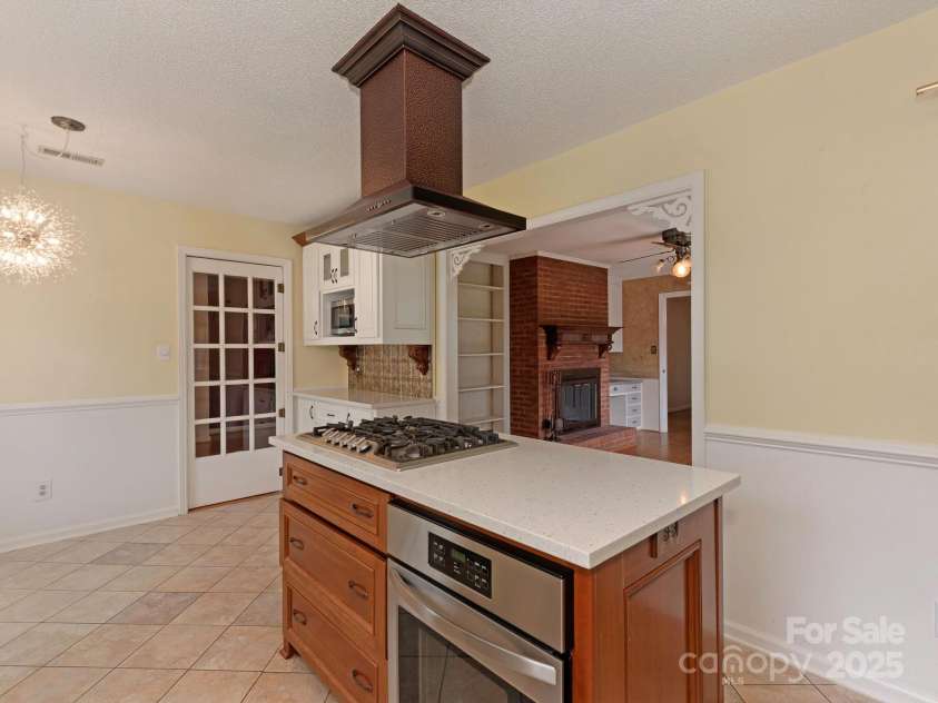 3408 Oak Tree Trail, Matthews, NC 28105.  MLS# CAR4267808, YatesRealty ID 17929. Additional counterspace across from breakfast nook, with GE microwave in the upper niche, cabinets below