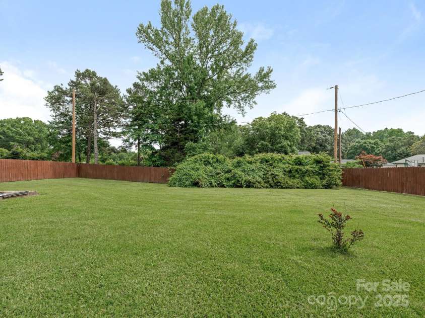 3408 Oak Tree Trail, Matthews, NC 28105.  MLS# CAR4267808, YatesRealty ID 17929. Back lawn area