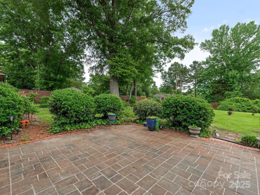 3408 Oak Tree Trail, Matthews, NC 28105.  MLS# CAR4267808, YatesRealty ID 17929. Back patio overlooking the grounds