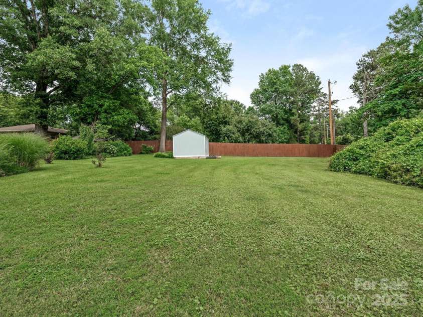 3408 Oak Tree Trail, Matthews, NC 28105.  MLS# CAR4267808, YatesRealty ID 17929. View of back lawn area