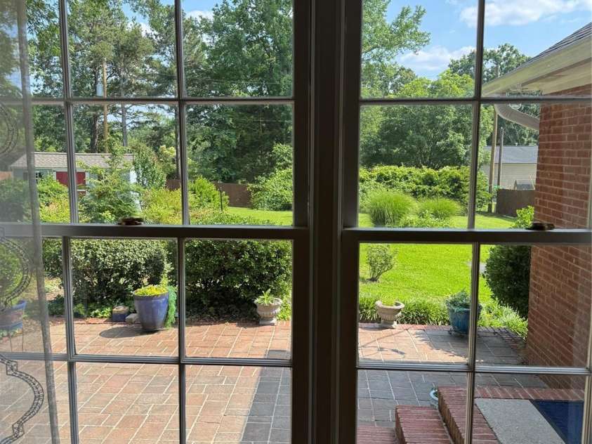 3408 Oak Tree Trail, Matthews, NC 28105.  MLS# CAR4267808, YatesRealty ID 17929. View of the yard and gardens from the den