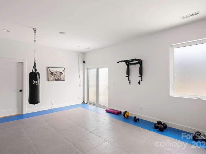 303 Iron Ridge Loop, Asheville, NC 28806.  MLS# CAR4151239, YatesRealty ID 1793. Lower Level Rec Room - Currently used as a Home Gym