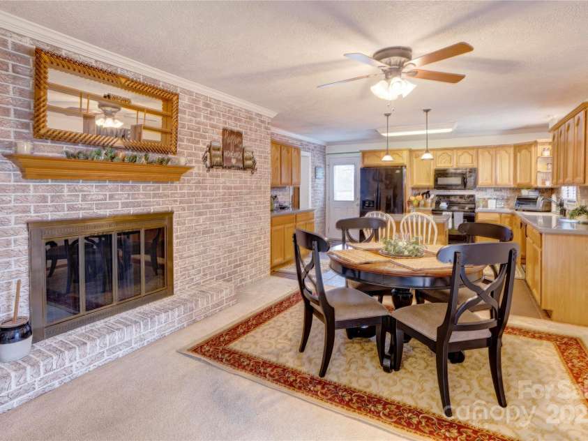 2004 Grandhaven Drive, Concord, NC 28027.  MLS# CAR4220214, YatesRealty ID 17934. Large fireplace in dining area.