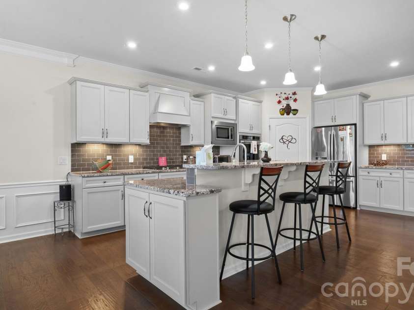 2017 Grove Place, Fort Mill, SC 29715.  MLS# CAR4372923, YatesRealty ID 17957. Island w/pendant lights and seating.