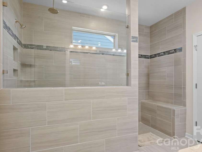 2017 Grove Place, Fort Mill, SC 29715.  MLS# CAR4372923, YatesRealty ID 17957. Zero entry spa-like walk-in Shower in Primary Bath.