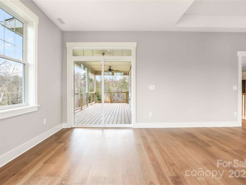 77 Creekside View Drive, Asheville, NC 28804.  MLS# CAR4109113, YatesRealty ID 17957. Primary bedroom has slider doors leading to upper level trex deck