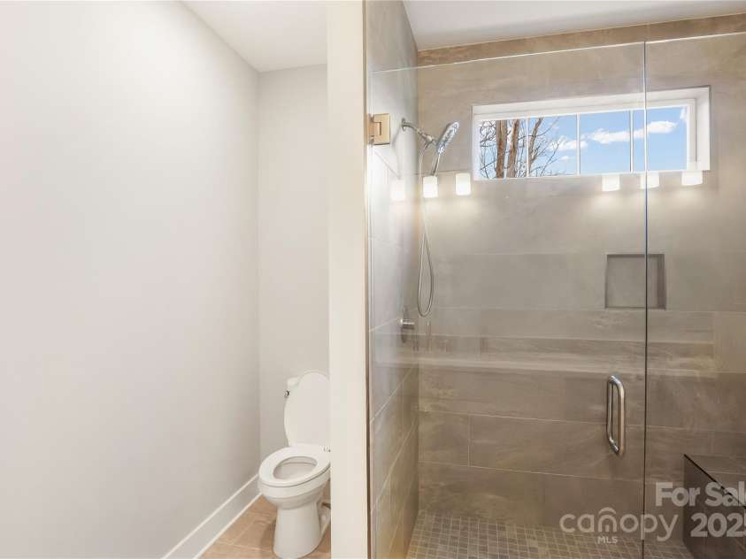 77 Creekside View Drive, Asheville, NC 28804.  MLS# CAR4109113, YatesRealty ID 17957. Primary tiled shower with bench in shower