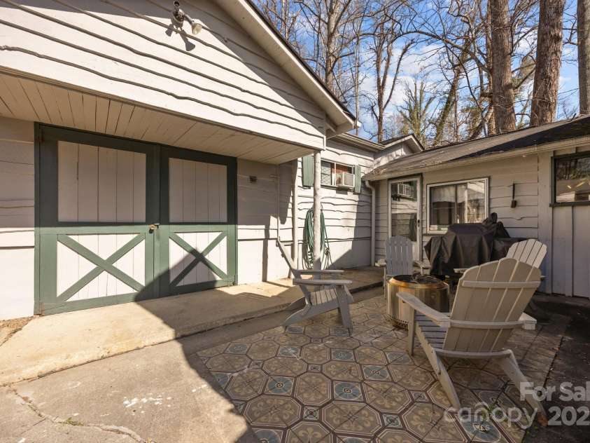 215 Cedar Lane, Arden, NC 28704.  MLS# CAR4224990, YatesRealty ID 1796. Carriage house for storage and laundry.