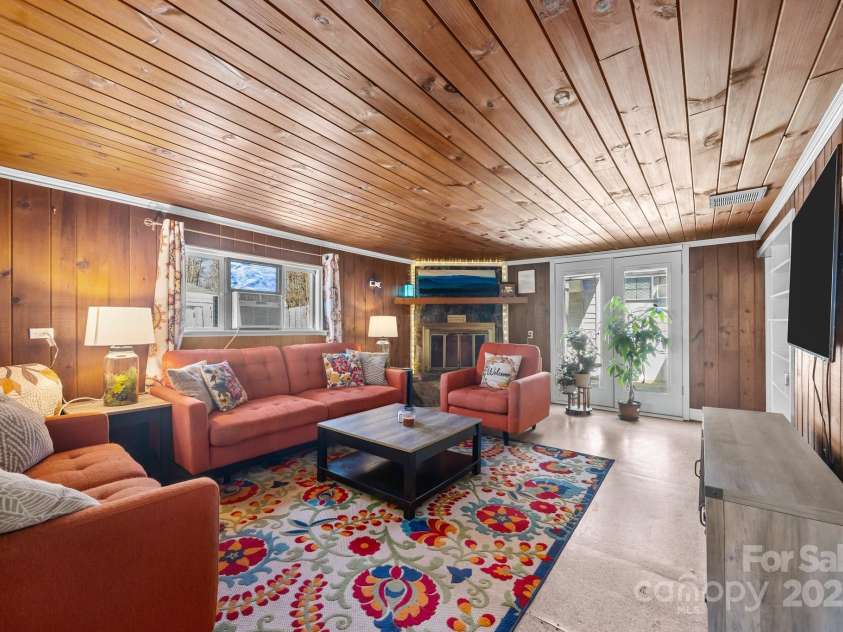 215 Cedar Lane, Arden, NC 28704.  MLS# CAR4224990, YatesRealty ID 1796. Living room with original cedar woodwork.