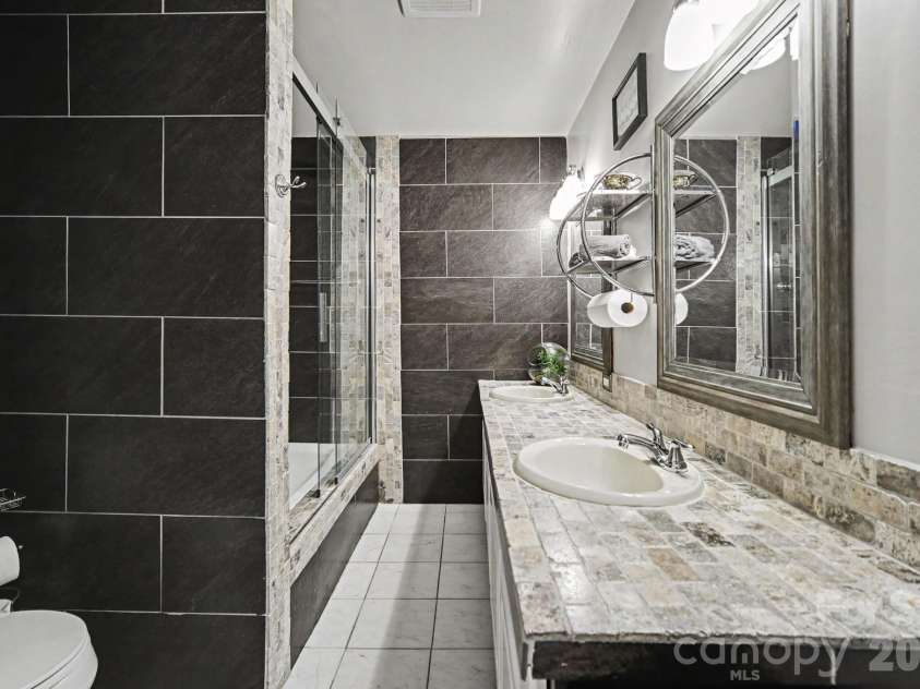 7108 Hollyhouse Drive, Charlotte, NC 28215.  MLS# CAR4366405, YatesRealty ID 17962. BASEMENT BATHROOM