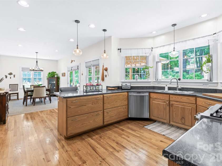 72 Whitfield Lane, Weaverville, NC 28787.  MLS# CAR4375022, YatesRealty ID 17966. Open kitchen with breakfast bar, dining area and access to back deck