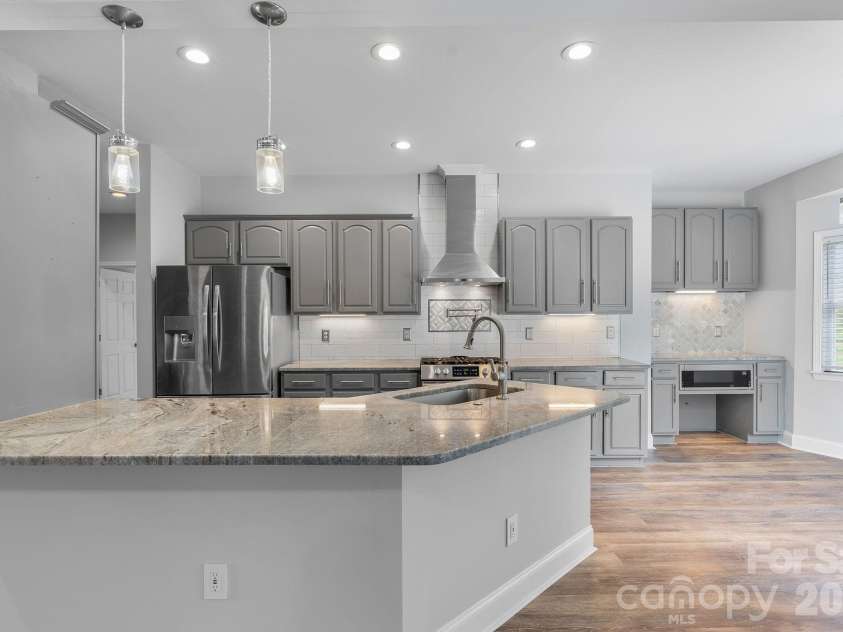 79 Mill Pond Way, Hendersonville, NC 28791.  MLS# CAR4363117, YatesRealty ID 17971. Open kitchen for ease and entertainment opens to the sunset with large cable decking for family, friends and entertainment.
