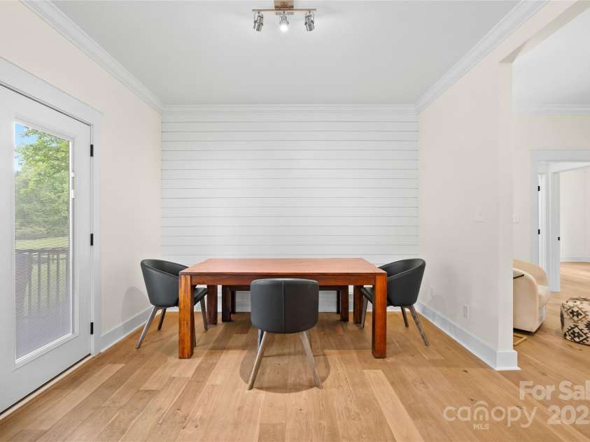 94 Jamestown Lane, Columbus, NC 28722.  MLS# CAR4262620, YatesRealty ID 17982. Dining area with shiplap wall. Double doors open out to an expansive rear deck.