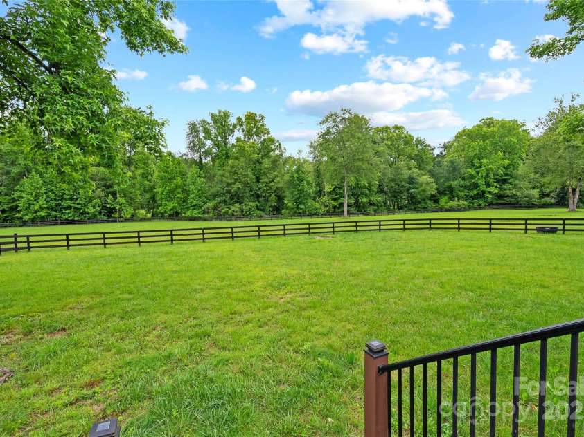 94 Jamestown Lane, Columbus, NC 28722.  MLS# CAR4262620, YatesRealty ID 17982. FLAT established pasture. A rare find in this mountain area. The back portion of the field is a flood plain from Hughes Creek, the area behind the fence did flood during Helene but the house and structures were not affect
