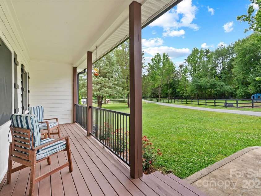 94 Jamestown Lane, Columbus, NC 28722.  MLS# CAR4262620, YatesRealty ID 17982. Front porch looks out over pasture and one of the barns.