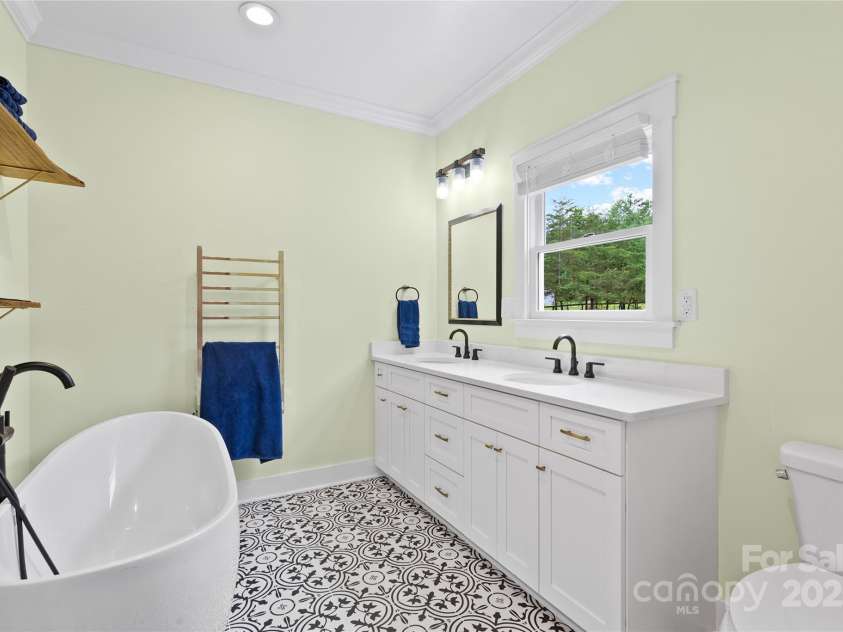94 Jamestown Lane, Columbus, NC 28722.  MLS# CAR4262620, YatesRealty ID 17982. Primary bathroom with big shower stall and soaking tub, heated towel rack.