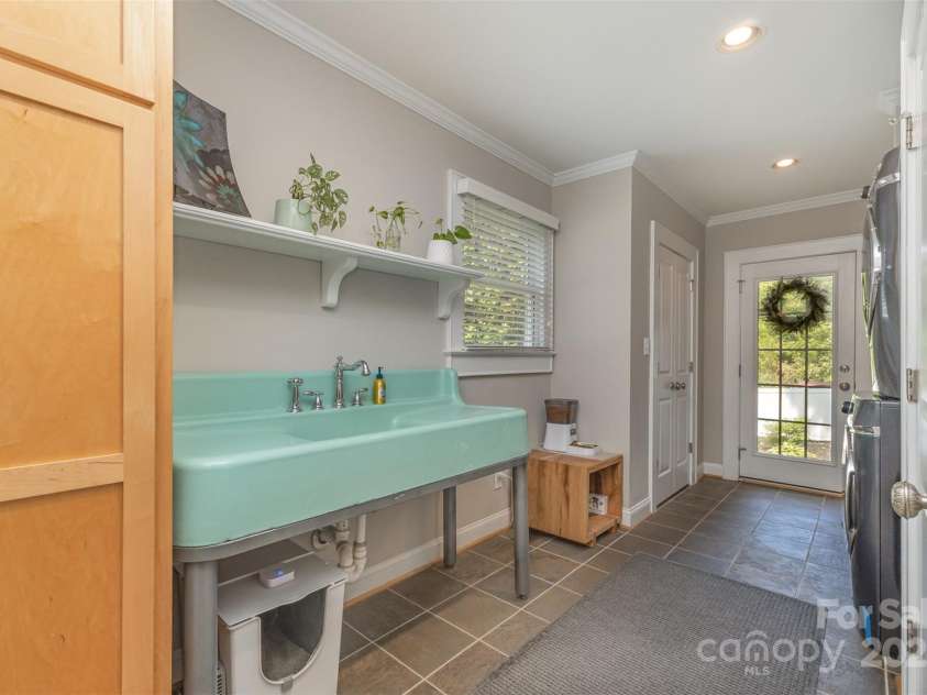 141 Eastover Drive, Concord, NC 28025.  MLS# CAR4264059, YatesRealty ID 17985. Laundry Room with an oversized sink & laundry chute (inside cabinet)