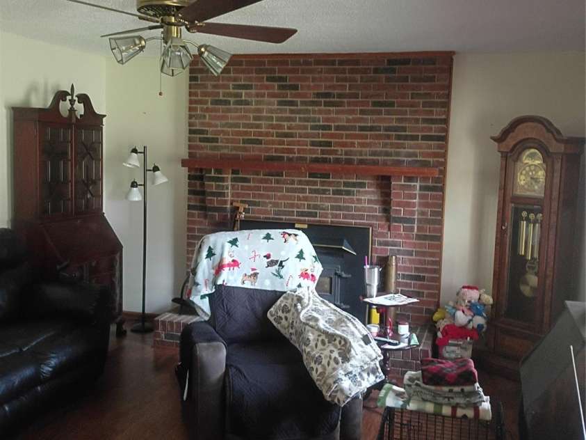 5427 Christopher Road, Iron Station, NC 28080.  MLS# CAR4367845, YatesRealty ID 17988. Living room Wood insert