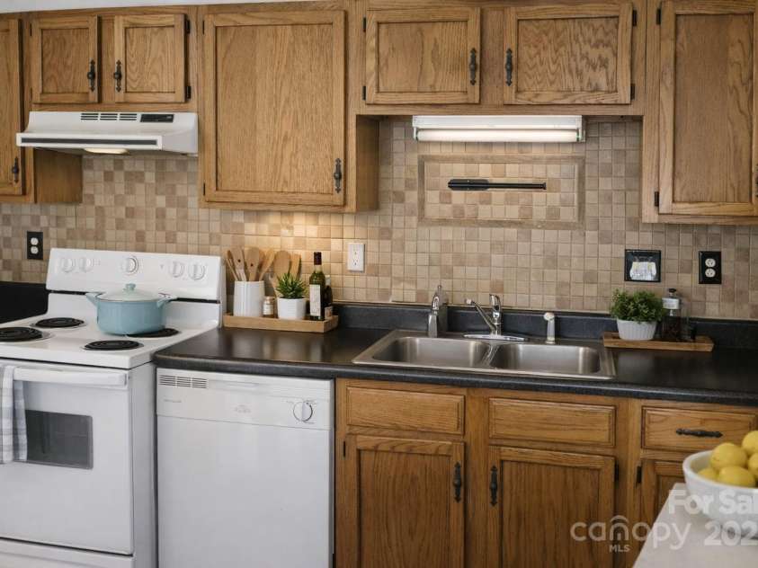 1614-H Arlyn Circle, Charlotte, NC 28213.  MLS# CAR4311725, YatesRealty ID 1799. AI staged kitchen